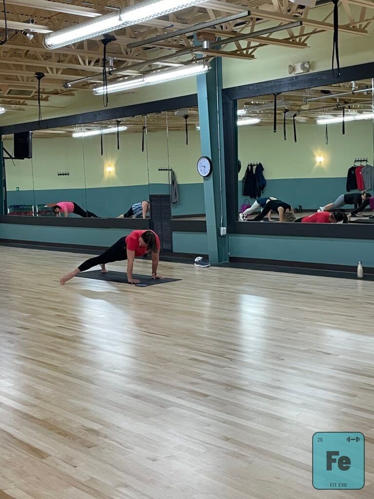 A member holding a side plank in the FIT EVO studio.