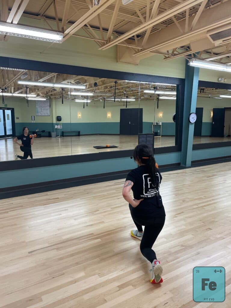 An instructor moving through a footwork drill in the FIT EVO studio.