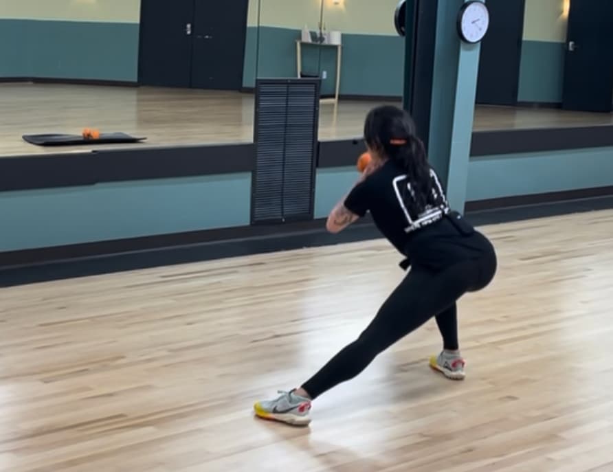 An instructor throwing a punch from a boxing stance in the FIT EVO studio.