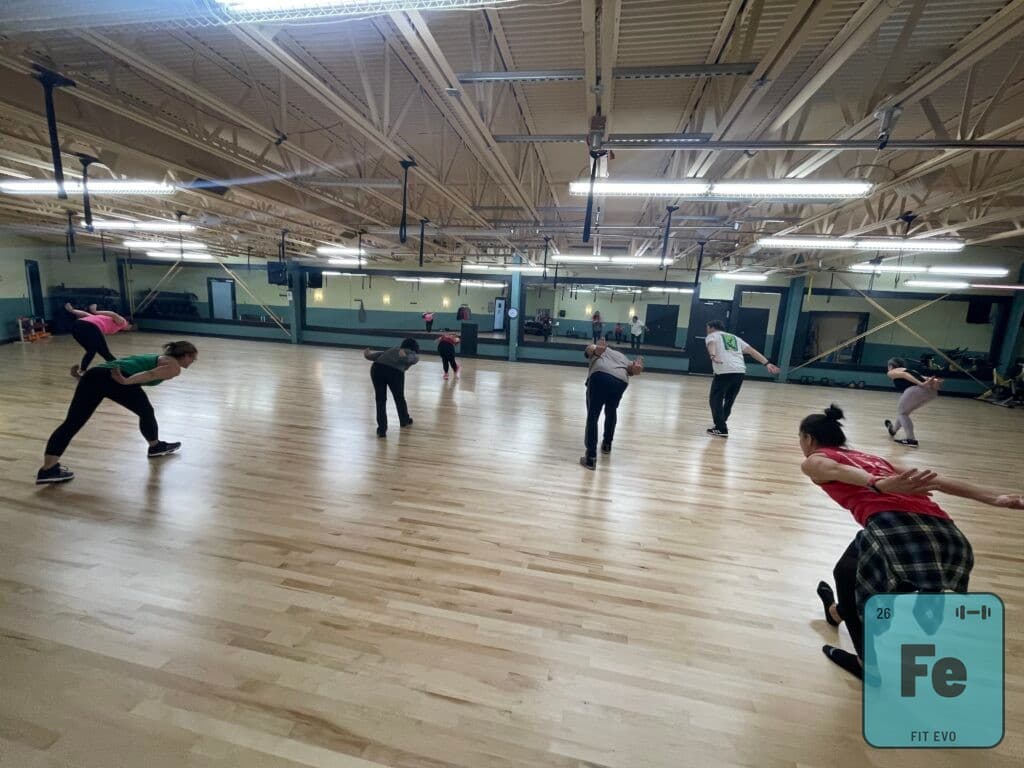 A class reaching wide across the floor of the FIT EVO studio.