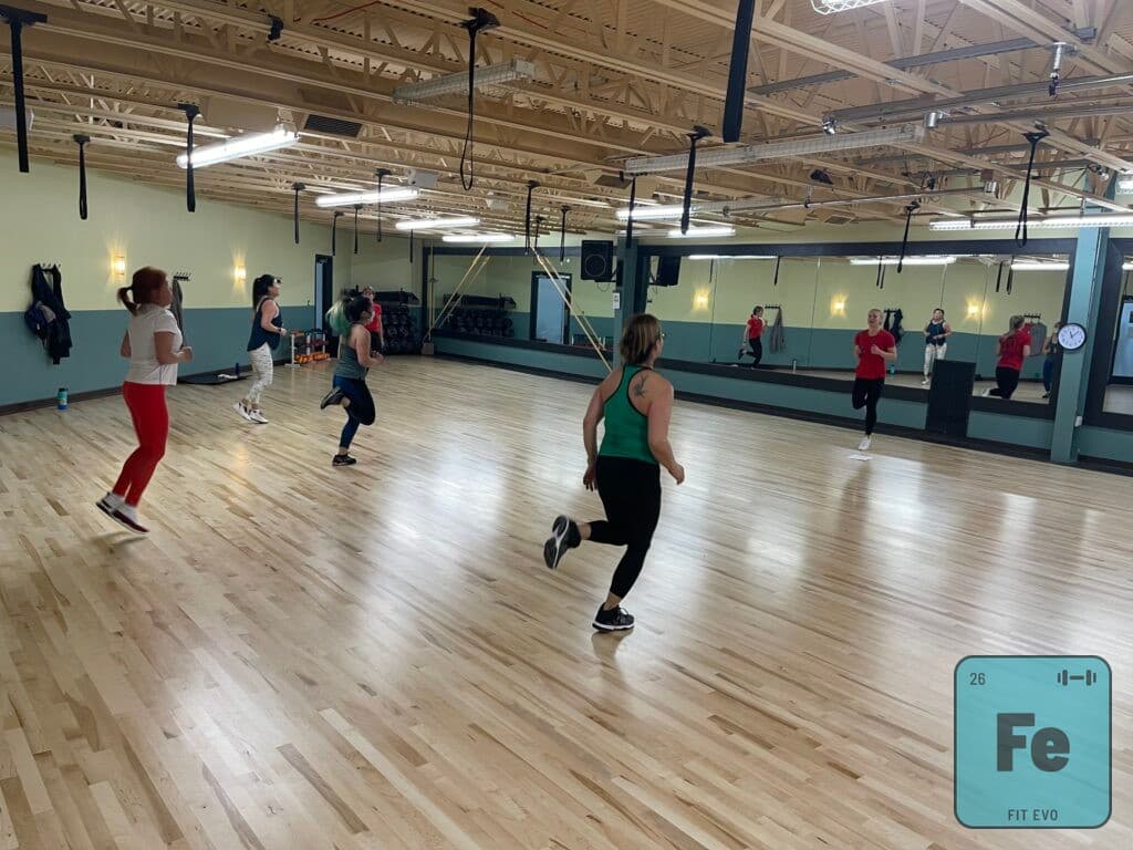 A cardio class moving across the floor of the FIT EVO studio.