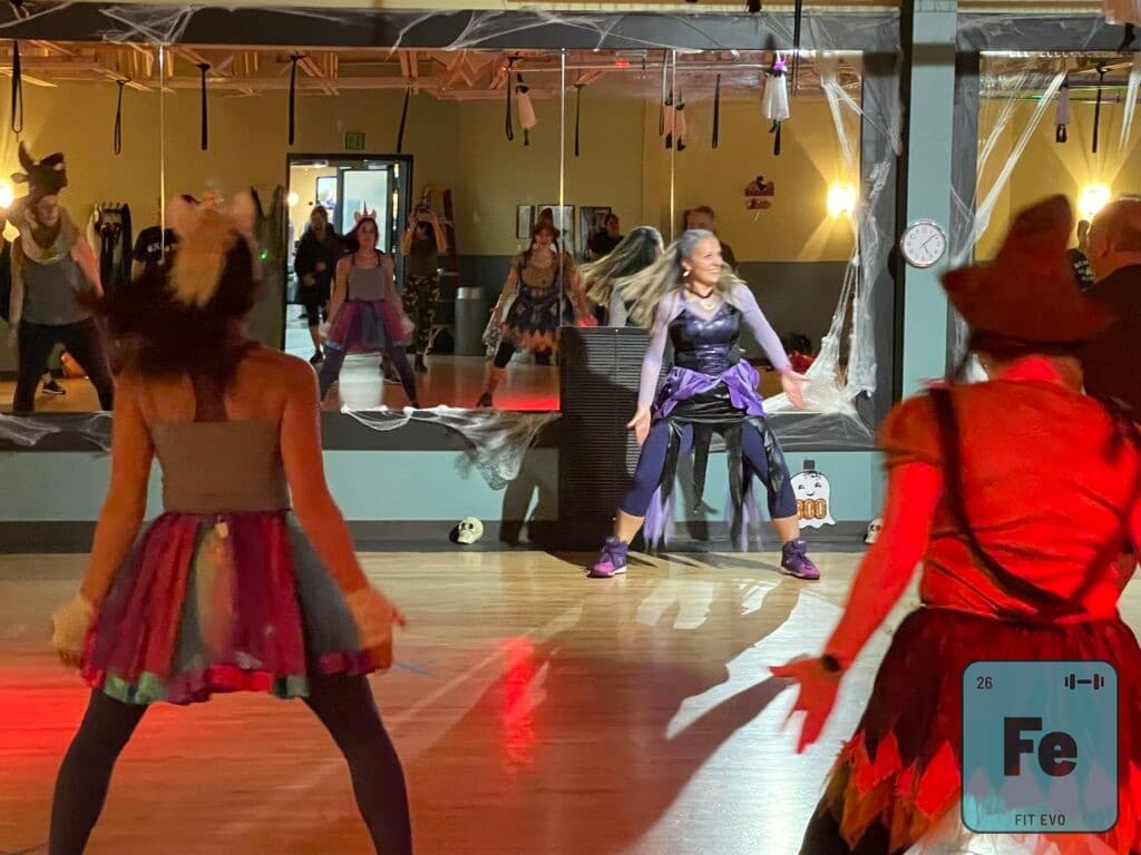Members in costume during a Halloween-themed dance fitness class at FIT EVO.
