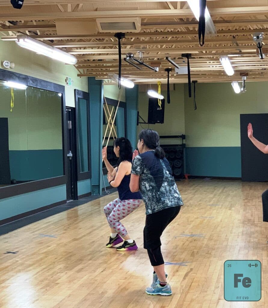 Two members following a class in the FIT EVO studio.