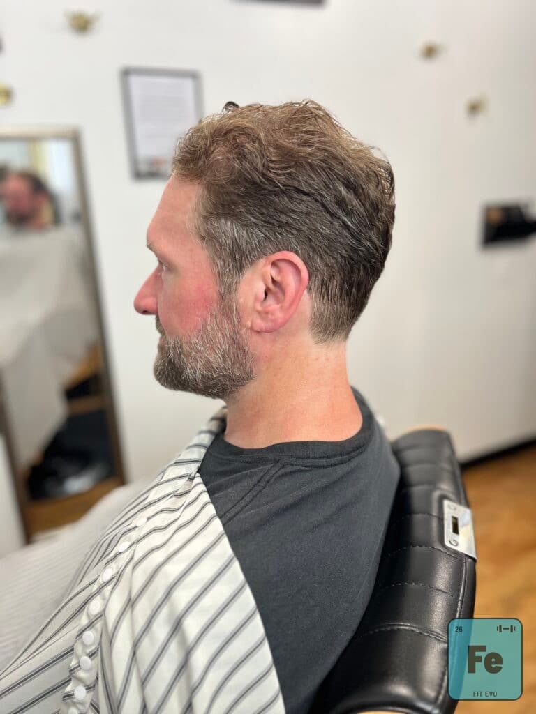 A member in the chair at Midtown Barber inside FIT EVO.
