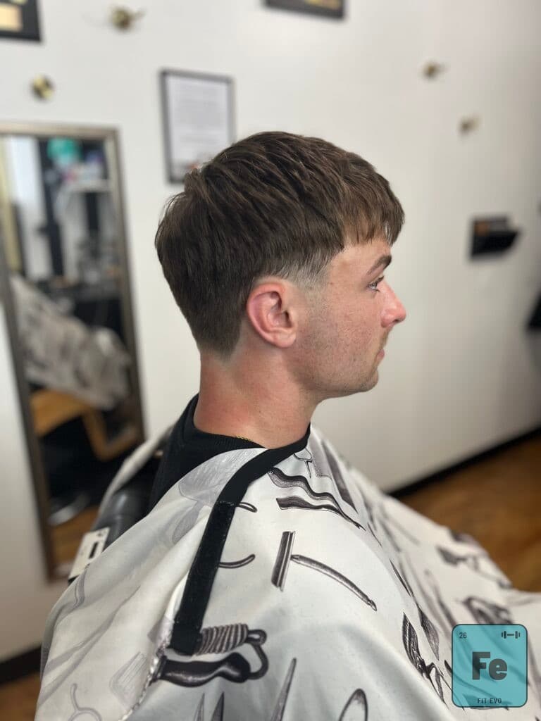 A member having his hair cut at Midtown Barber inside FIT EVO.