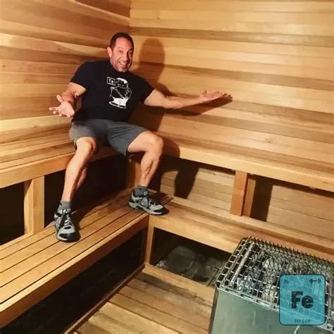 A member sitting on the cedar benches inside the FIT EVO sauna.