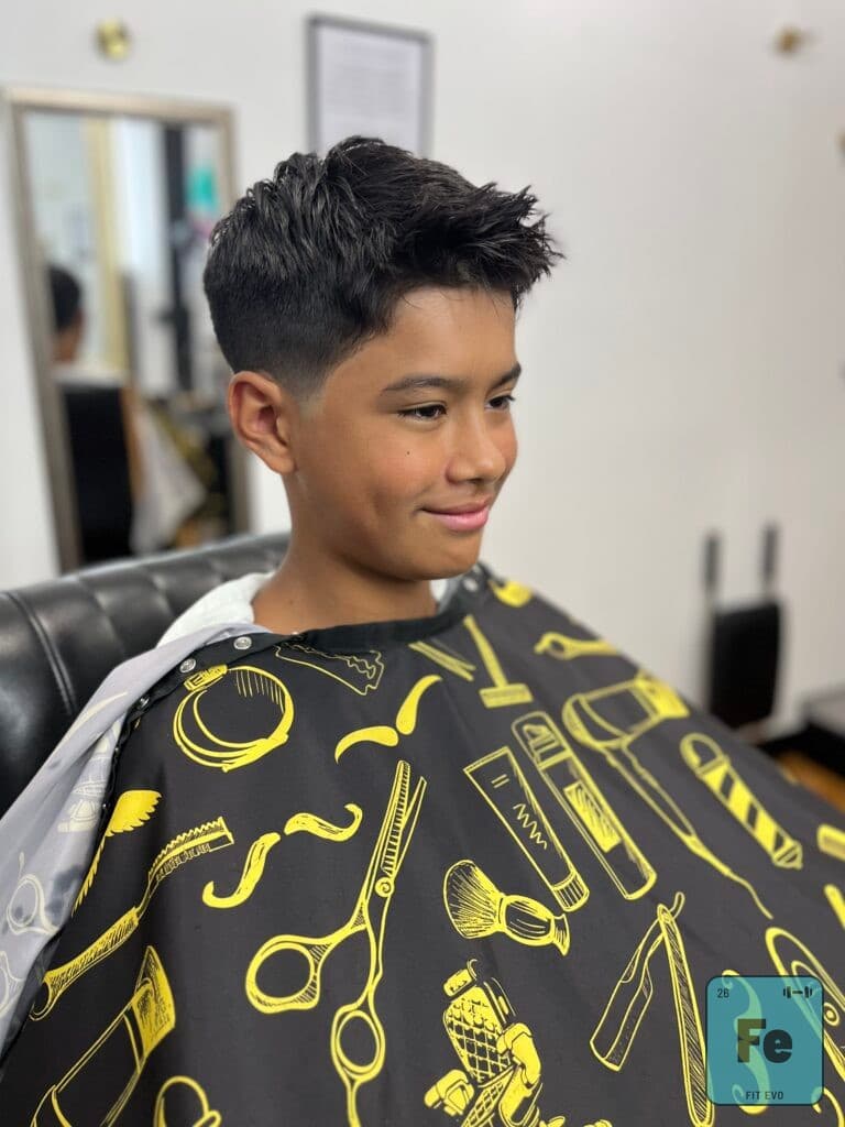 A young client after a haircut at Midtown Barber inside FIT EVO.