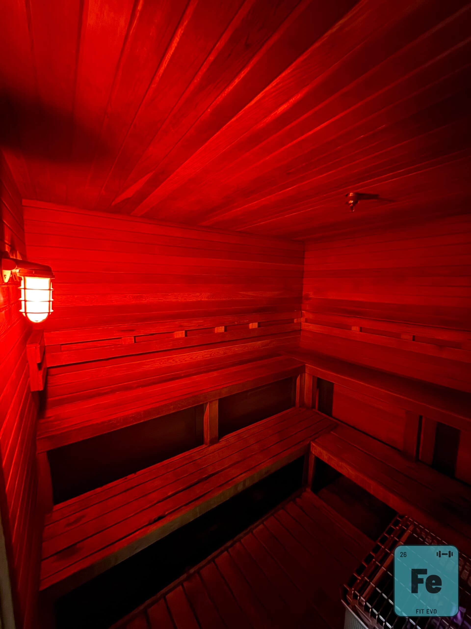 The interior of the FIT EVO sauna under red light.