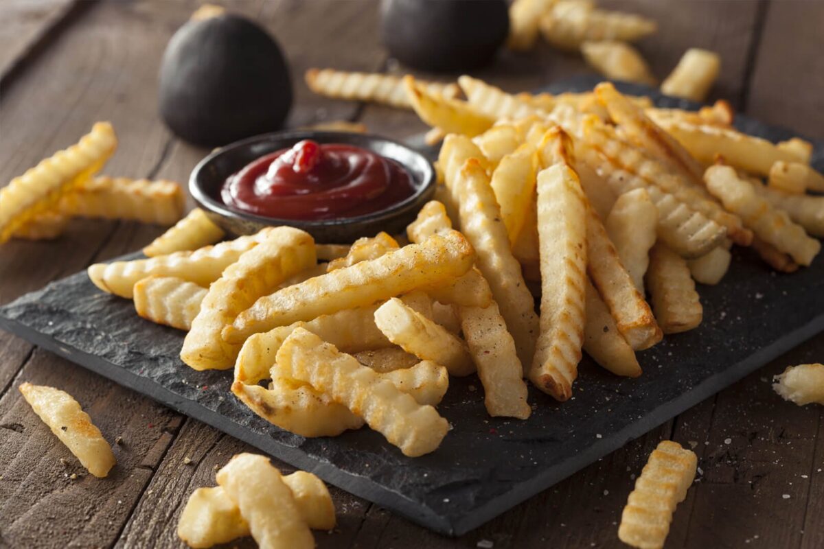 fries with ketchup wood background