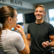 young woman talking to her personal trainer in gym 1